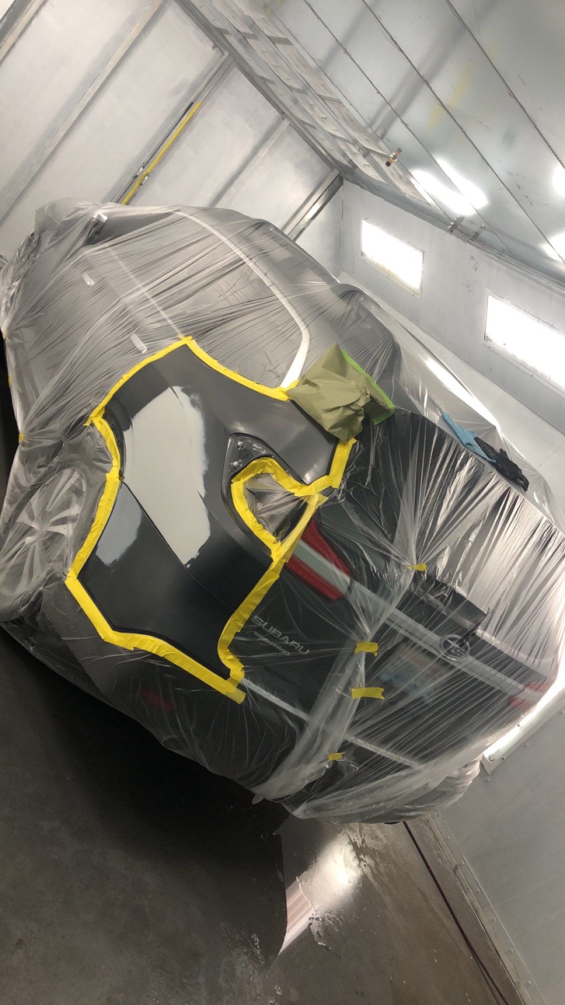 Quarter panel before - Subaru in paint booth prep